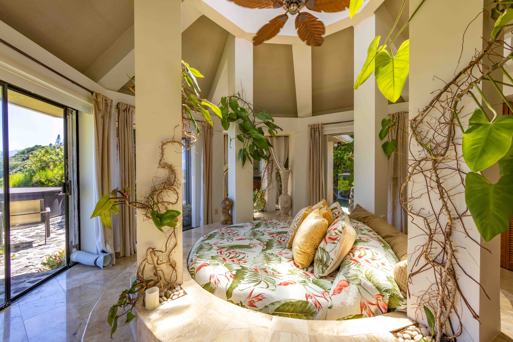 Waterfall House: Master bedroom w/ tall windows overlooking the ocean and round seven foot open style bed